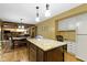 Kitchen view highlighting the island with granite counters, open to the dining area, and modern finishes at 974 Arrowwood Dr, Carmel, IN 46033