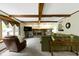 Bright living room with fireplace, exposed wood beams, and cozy furniture at 974 Arrowwood Dr, Carmel, IN 46033