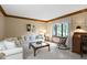 Bright living room with comfortable seating and natural light from the window at 974 Arrowwood Dr, Carmel, IN 46033