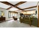 Spacious living room with exposed wood beams, fireplace, and comfortable seating at 974 Arrowwood Dr, Carmel, IN 46033