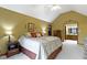 This primary bedroom offers vaulted ceilings, neutral walls, and an attached bathroom with double sinks at 974 Arrowwood Dr, Carmel, IN 46033
