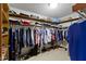 This walk-in closet features carpeted floors, shelving and clothing racks for optimal storage and organization at 974 Arrowwood Dr, Carmel, IN 46033