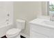 Bathroom showcasing a toilet, shower-tub combo, white vanity and dark hardwood flooring at 104 Maxim Ct, Cumberland, IN 46229