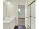 Bathroom with double sinks, wood floors, shower stall and open door at 104 Maxim Ct, Cumberland, IN 46229