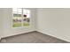 Bedroom with neutral carpet, fresh paint, and a window overlooking the neighborhood at 104 Maxim Ct, Cumberland, IN 46229
