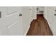 Bright hallway with new hardwood floors and white doors, leading to various rooms at 104 Maxim Ct, Cumberland, IN 46229
