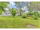 Expansive backyard featuring lush green grass and mature trees, perfect for outdoor activities and relaxation at 1124 S Lockburn St, Indianapolis, IN 46241