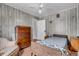 Bedroom with wood-paneled walls, wood furniture, creating a rustic, comfortable space at 1124 S Lockburn St, Indianapolis, IN 46241