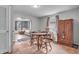 Inviting dining room with hardwood floors, a classic table set, and a view of the living area at 1124 S Lockburn St, Indianapolis, IN 46241