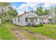 Quaint single-story home with a welcoming porch and a driveway, surrounded by green grass at 1124 S Lockburn St, Indianapolis, IN 46241