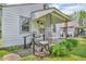 Charming home featuring a covered front porch with decorative iron supports and space to sit at 1124 S Lockburn St, Indianapolis, IN 46241