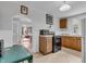 Open kitchen with archway to living room, classic cabinets, and view of a cozy living space at 1124 S Lockburn St, Indianapolis, IN 46241