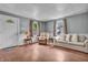 Sunlit living room featuring hardwood floors, neutral walls, and cozy seating at 1124 S Lockburn St, Indianapolis, IN 46241