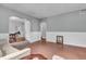 Spacious living room with hardwood floors, neutral walls, and a glimpse into other rooms at 1124 S Lockburn St, Indianapolis, IN 46241