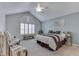 Cozy bedroom featuring a vaulted ceiling, plantation shutters, and sitting area at 1130 Deerbrook Trl, Greenwood, IN 46142