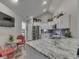Well-lit kitchen featuring stainless steel appliances, marble countertops, white cabinets, and open dining space at 1130 Deerbrook Trl, Greenwood, IN 46142