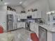 Bright kitchen with white cabinetry, stainless steel appliances, marble countertops, and a modern backsplash at 1130 Deerbrook Trl, Greenwood, IN 46142