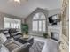 Comfortable living room with fireplace, large windows, and stylish furnishings at 1130 Deerbrook Trl, Greenwood, IN 46142