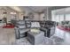 Comfortable living room featuring a gray leather sectional sofa, large wall clock, and open floor plan at 1130 Deerbrook Trl, Greenwood, IN 46142
