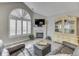 Bright living room with fireplace, large windows, and stylish furniture at 1130 Deerbrook Trl, Greenwood, IN 46142