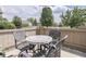 Private patio featuring a mosaic-topped table and comfortable seating within a fenced area at 1130 Deerbrook Trl, Greenwood, IN 46142