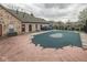 Community pool with a safety cover; a stone building is nearby at 1130 Deerbrook Trl, Greenwood, IN 46142