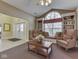 Inviting sitting area with a window seat, built-in bookshelves, and comfortable chairs at 1130 Deerbrook Trl, Greenwood, IN 46142