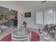 Cozy sunroom showcasing wicker furniture set on a red rug, complemented by natural light and neutral walls at 1130 Deerbrook Trl, Greenwood, IN 46142