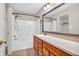 Bathroom with a large mirror, wood cabinets and a shower-tub combination at 1139 Fernwood Way, Plainfield, IN 46168