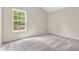 Bright bedroom features neutral walls, plush carpeting, and a large window with a view of trees at 1139 Fernwood Way, Plainfield, IN 46168