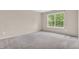 A bright bedroom with a neutral color palette and a large window at 1139 Fernwood Way, Plainfield, IN 46168