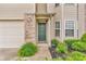 View of the home's front door, with green door, brick facade, and tidy landscaping at 1139 Fernwood Way, Plainfield, IN 46168