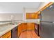 Kitchen featuring oak cabinets, granite counters, and black appliances at 1139 Fernwood Way, Plainfield, IN 46168