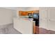 View of the kitchen area featuring oak cabinets, breakfast bar, and granite countertops at 1139 Fernwood Way, Plainfield, IN 46168