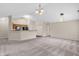 Open-concept living space featuring neutral carpet, vaulted ceilings, and an open kitchen at 1139 Fernwood Way, Plainfield, IN 46168