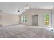 Spacious living room featuring neutral walls, high ceilings, a large window, and sliding glass doors at 1139 Fernwood Way, Plainfield, IN 46168