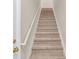 Carpeted stairway with white banister and gold hardware at 1139 Fernwood Way, Plainfield, IN 46168