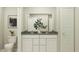 Bathroom features a double vanity, toilet, decorative vase, and neutral wall art at 11626 Aubrey Ln, Fishers, IN 46040
