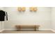 Organized walk-in closet with shelving, hanging space, and a stylish wooden bench at 11626 Aubrey Ln, Fishers, IN 46040