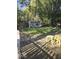 Tranquil backyard featuring a quaint shed, an outdoor dining area, and a firepit, perfect for entertaining at 1212 River Heights Dr, Indianapolis, IN 46240