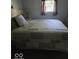 Comfortable bedroom features natural light with a decorative bed frame, and window at 1212 River Heights Dr, Indianapolis, IN 46240