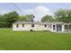 A spacious backyard showcasing a well-maintained lawn, patio, and the house's exterior at 125 S Alfonte St, Ingalls, IN 46048