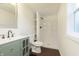 Modern bathroom with a vanity, toilet, and standup shower with dark brown vinyl flooring at 125 S Alfonte St, Ingalls, IN 46048