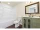 Bathroom with tub/shower, dark bronze hardware, decorative mirror and stylish vanity at 125 S Alfonte St, Ingalls, IN 46048