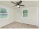 Bedroom features neutral carpet, neutral paint, two large windows and closet at 125 S Alfonte St, Ingalls, IN 46048