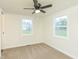 Bright bedroom featuring neutral walls, carpet, a ceiling fan, and natural light from two windows at 125 S Alfonte St, Ingalls, IN 46048