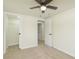 Bedroom with neutral walls, carpet, ceiling fan, and doors to the closet and hall at 125 S Alfonte St, Ingalls, IN 46048