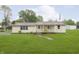 Charming single-story home featuring a well-maintained lawn and inviting front porch with an American flag at 125 S Alfonte St, Ingalls, IN 46048