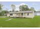Charming single-story home featuring a well-maintained lawn and inviting front porch with an American flag at 125 S Alfonte St, Ingalls, IN 46048