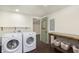 Spacious laundry room with front load washer and dryer, shelving and wooden folding table at 125 S Alfonte St, Ingalls, IN 46048